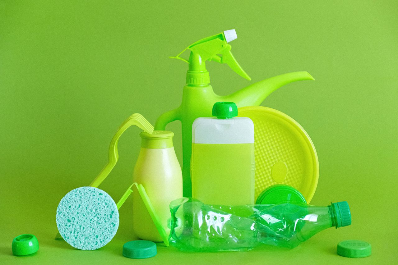 team-03 Monochrome green bottles and containers for liquids or gel with plastic bottle and lids on green background